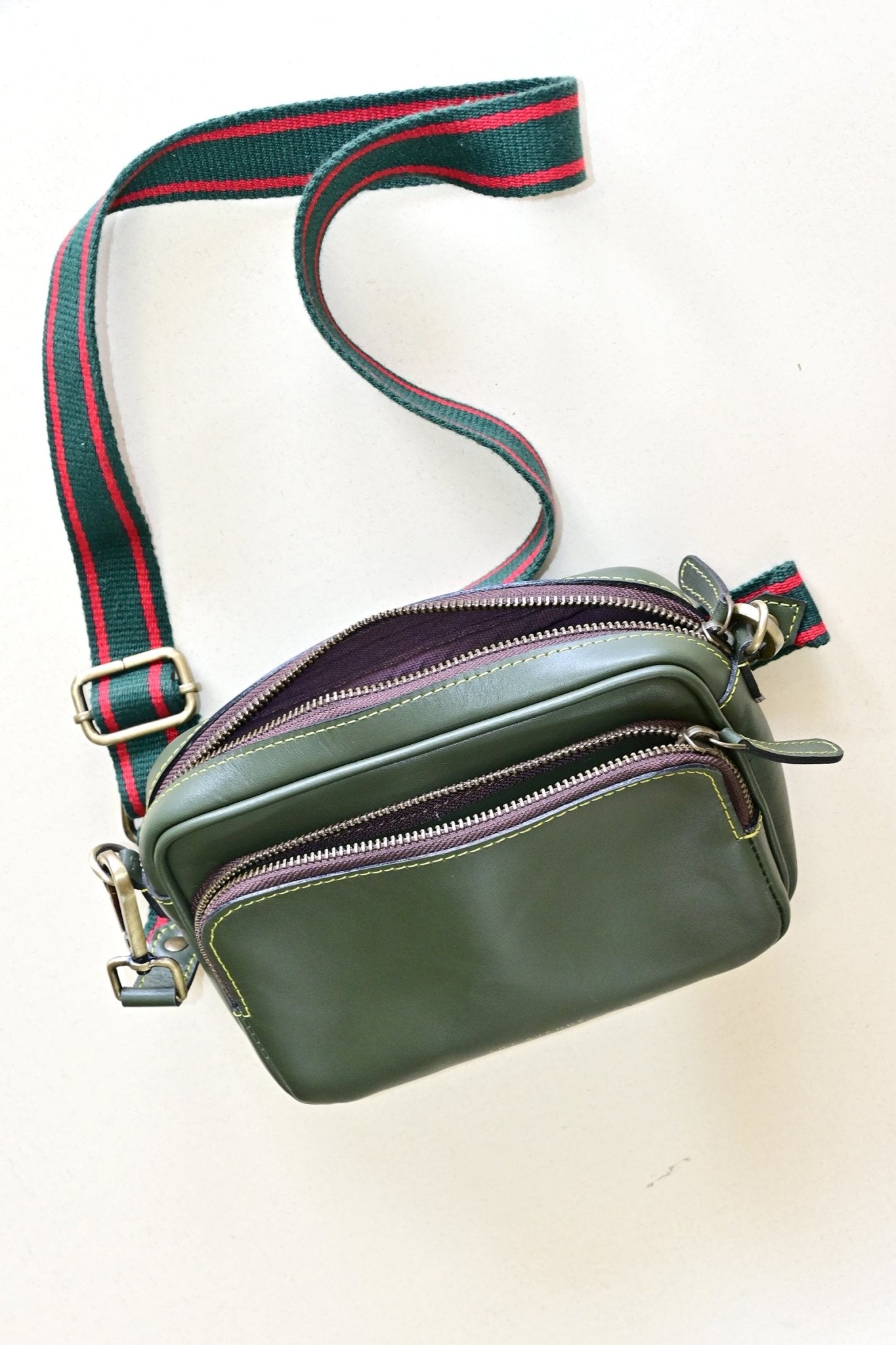 Harisson green leather sling bag flat lay — Art Avenue