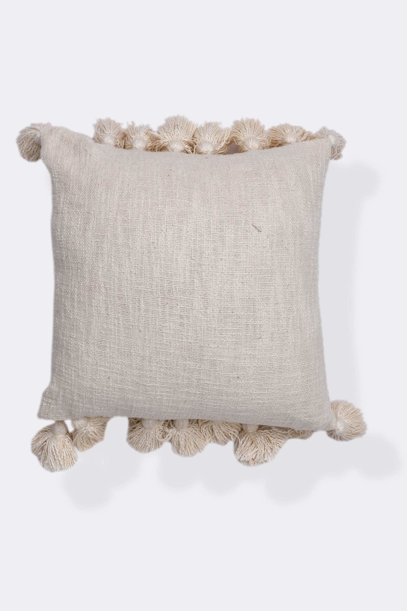 Hand-embroidered square cushion on sofa — Art Avenue