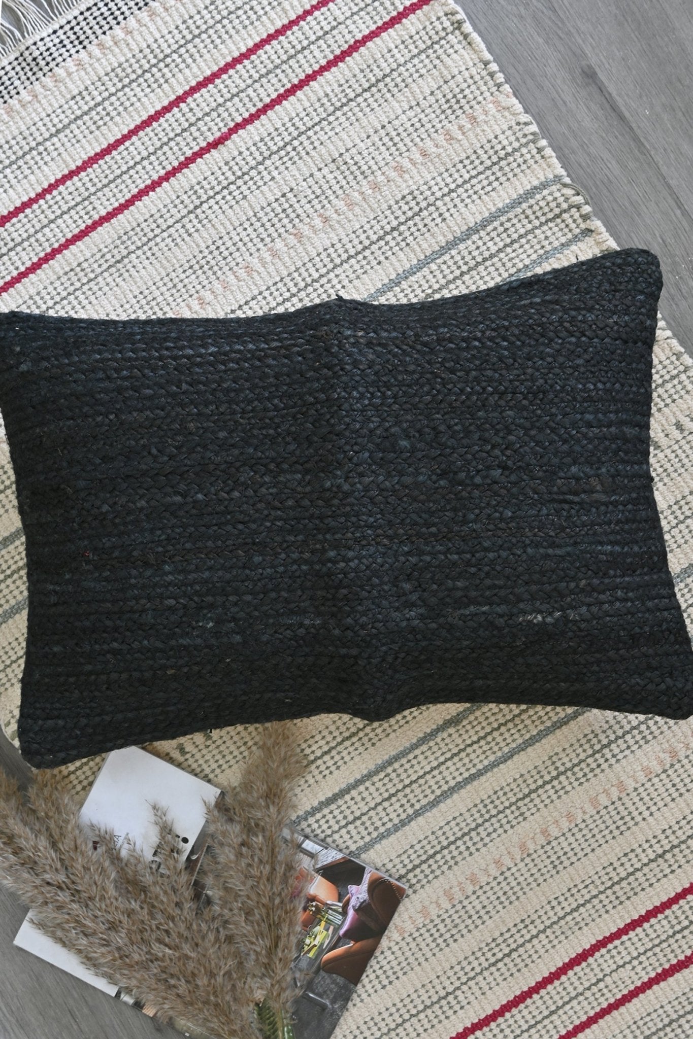 Overdyed braided jute lumbar cushion on sofa — Art Avenue