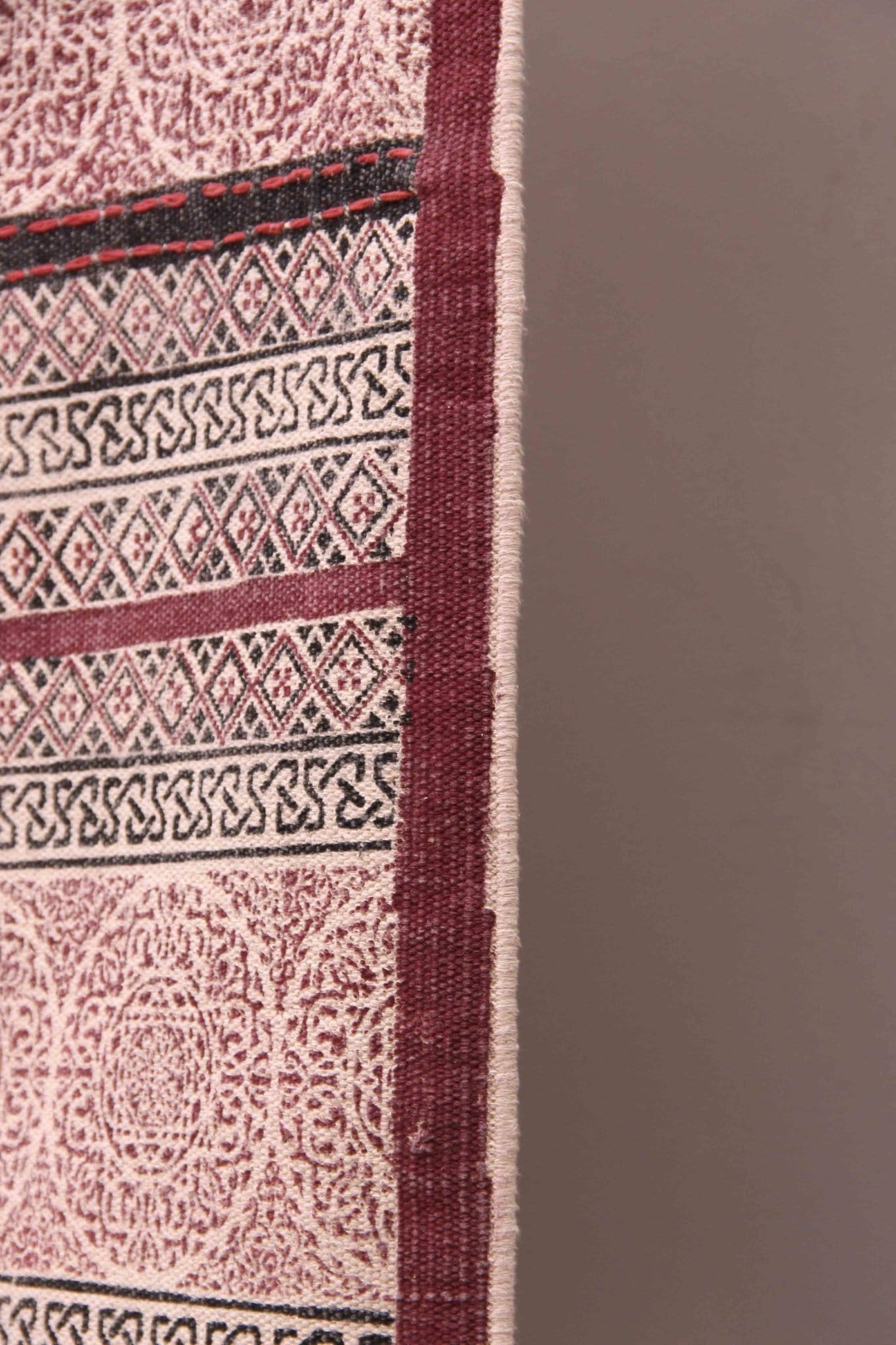 Detail of block-print on maroon dhurrie rug — Art Avenue