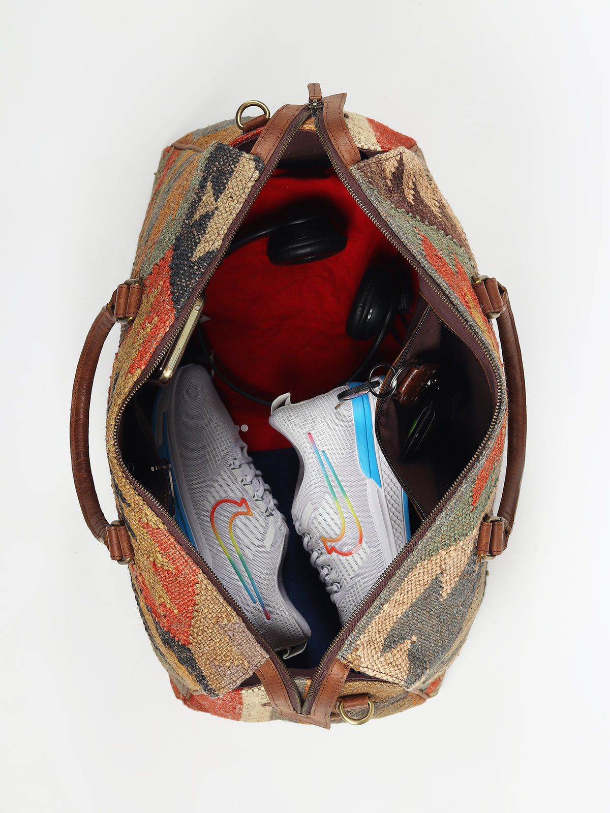 Sharant kilim and leather duffle bag flat lay — Art Avenue