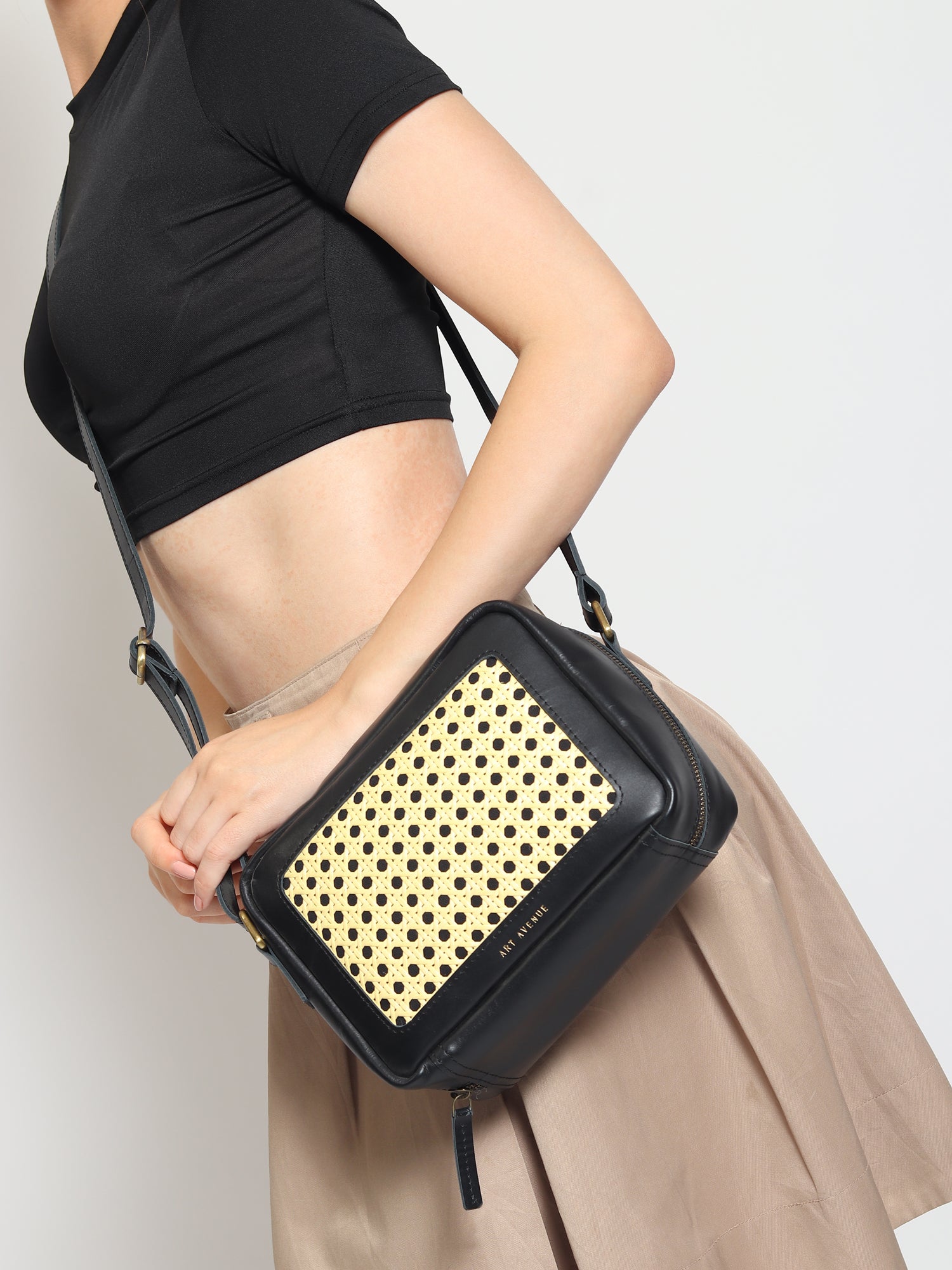 Laremy cane and leather sling bag flat lay — Art Avenue