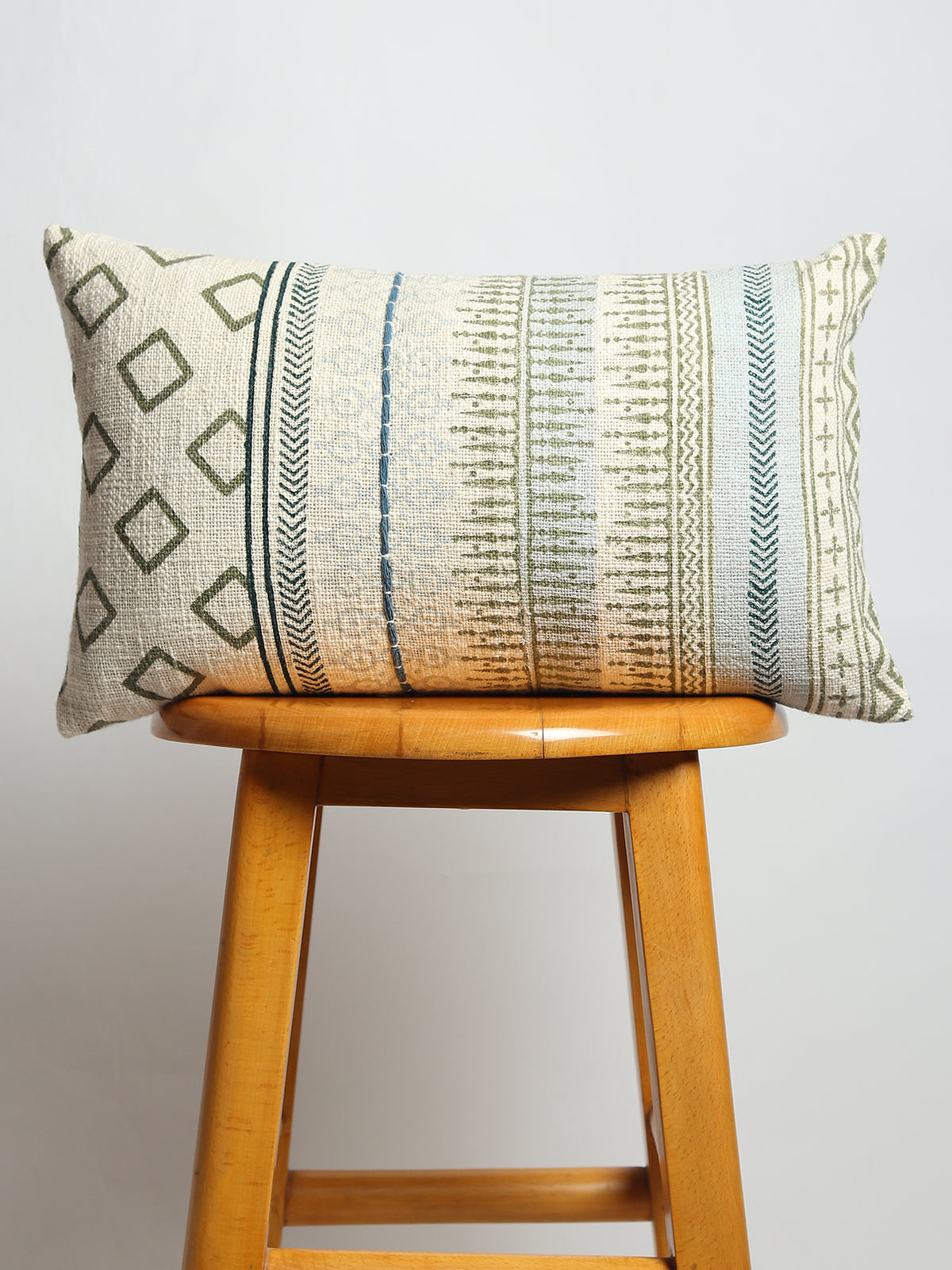 Block-printed embroidered lumbar cushion on sofa — Art Avenue