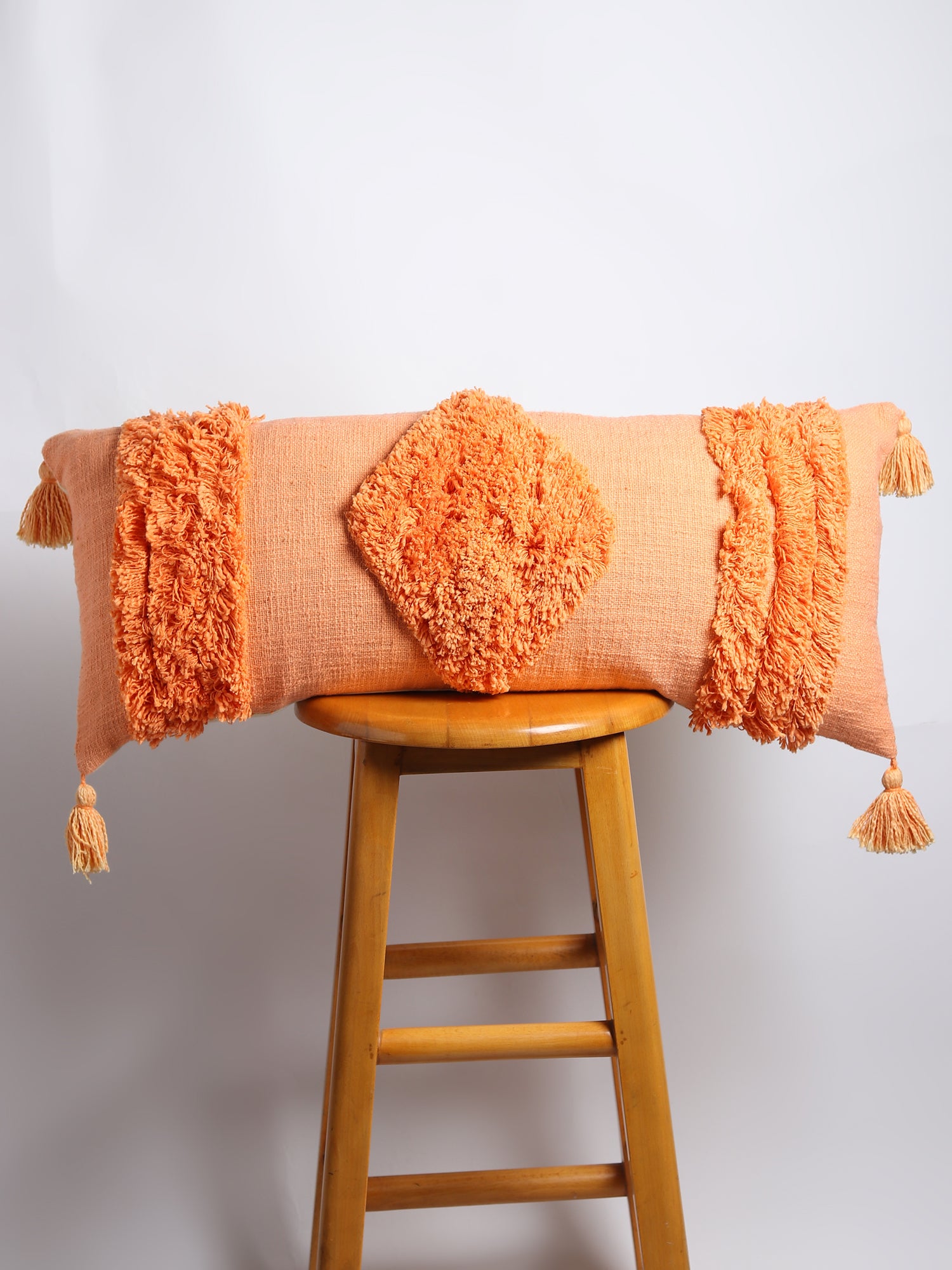 Overdyed shaggy lumbar cushion on sofa — Art Avenue