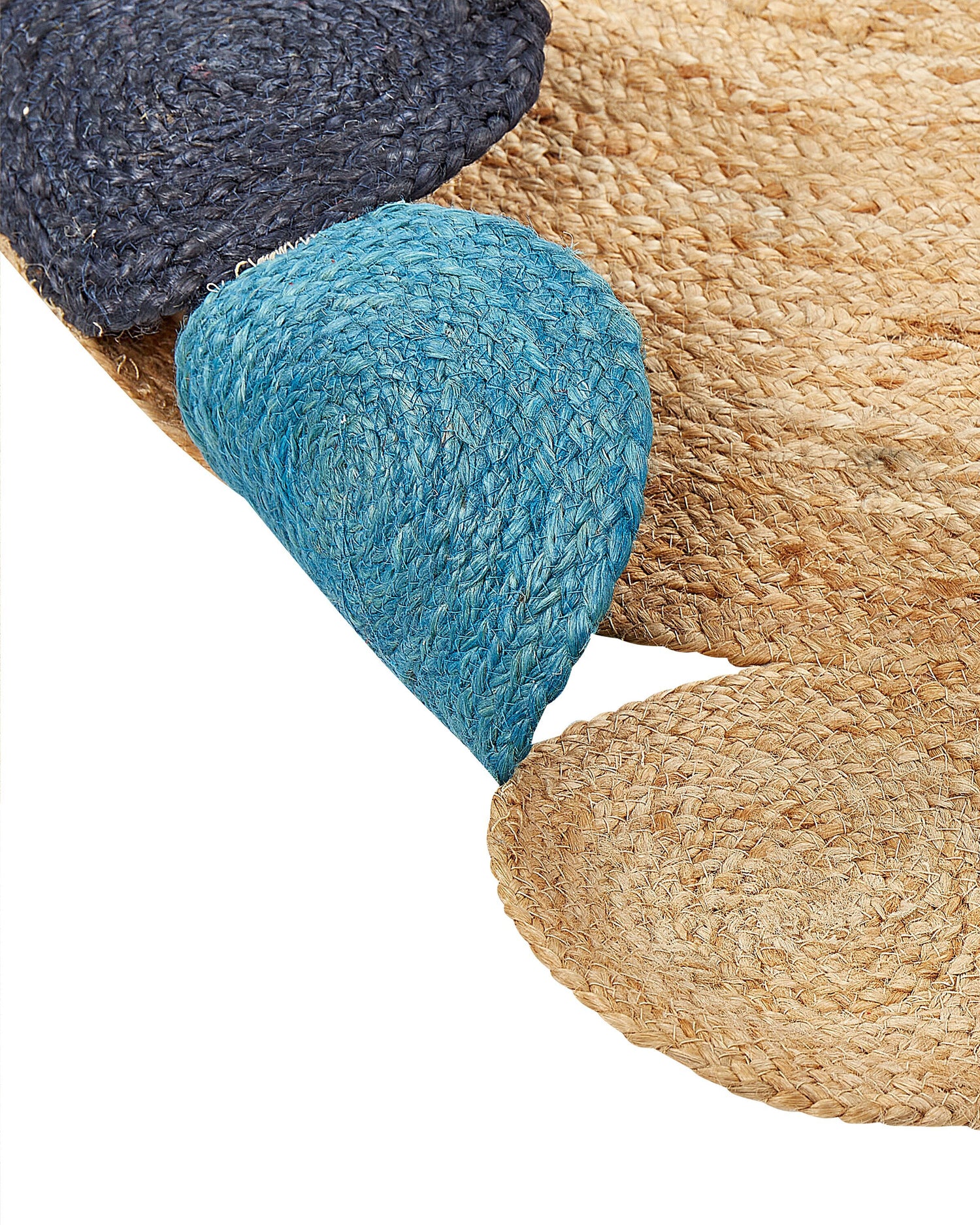 Close-up of the DUSTER - ROUND JUTE RUG, a handmade piece crafted from natural fibers, featuring overlapping circular sections in beige, light blue, and dark blue tones.