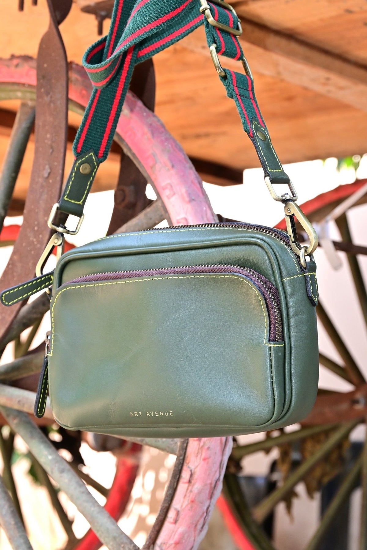 Harisson green sling bag on model — Art Avenue