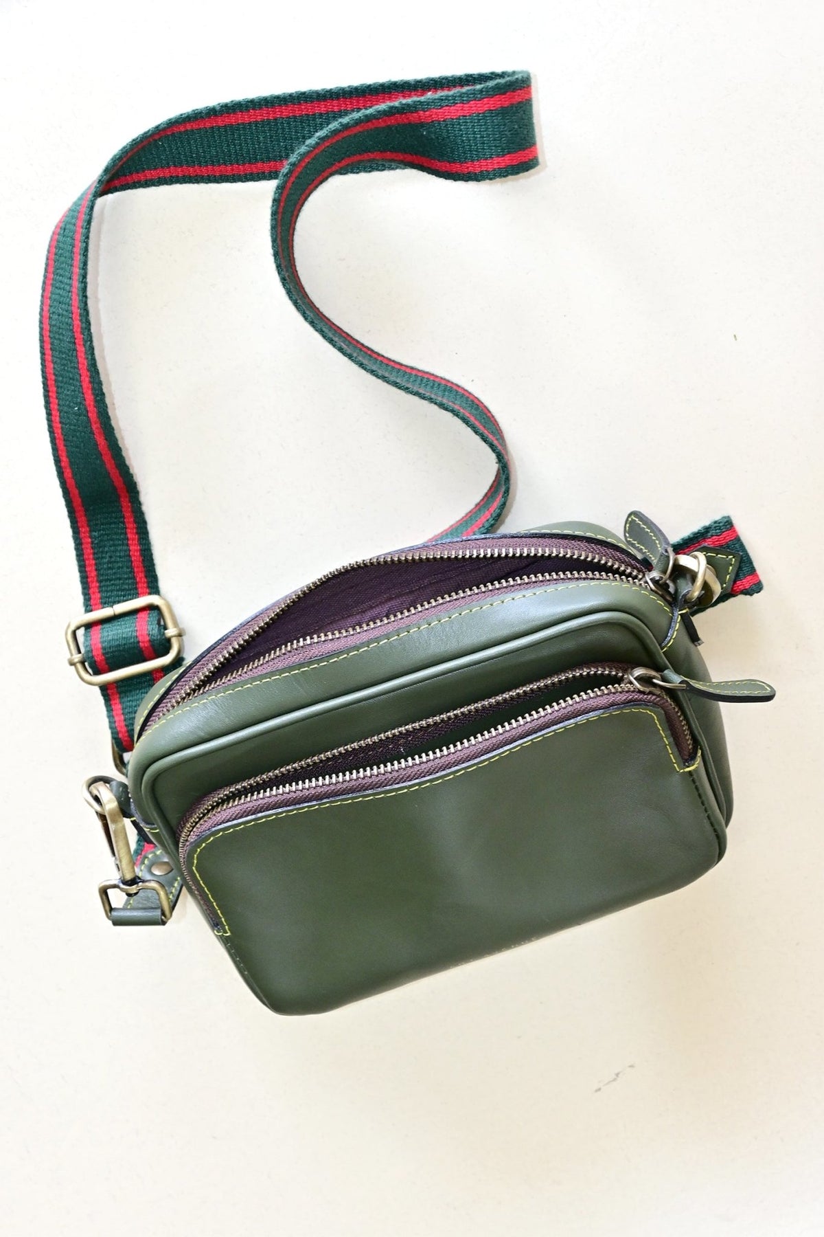 Harisson green leather sling bag flat lay — Art Avenue