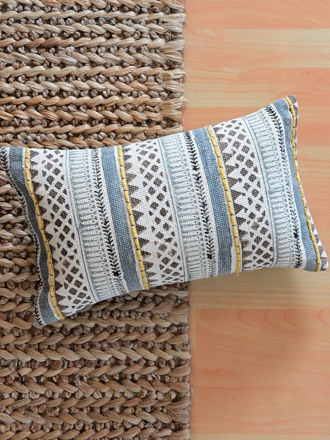 Block-printed embroidered lumbar cushion on sofa — Art Avenue