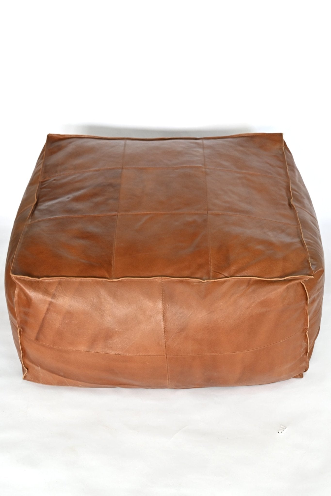 Harper leather pouf — room setting, Art Avenue