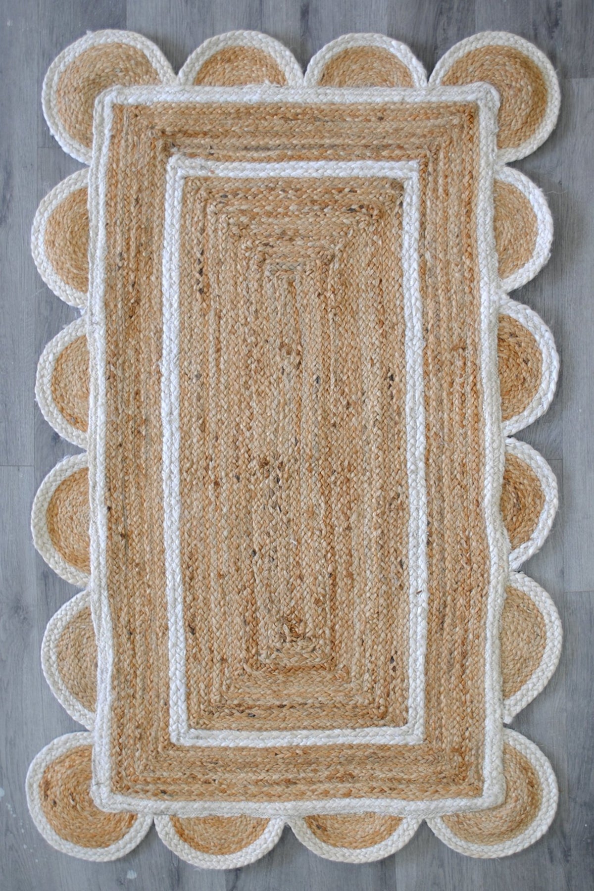 Nephron braided jute rug room setting — Art Avenue