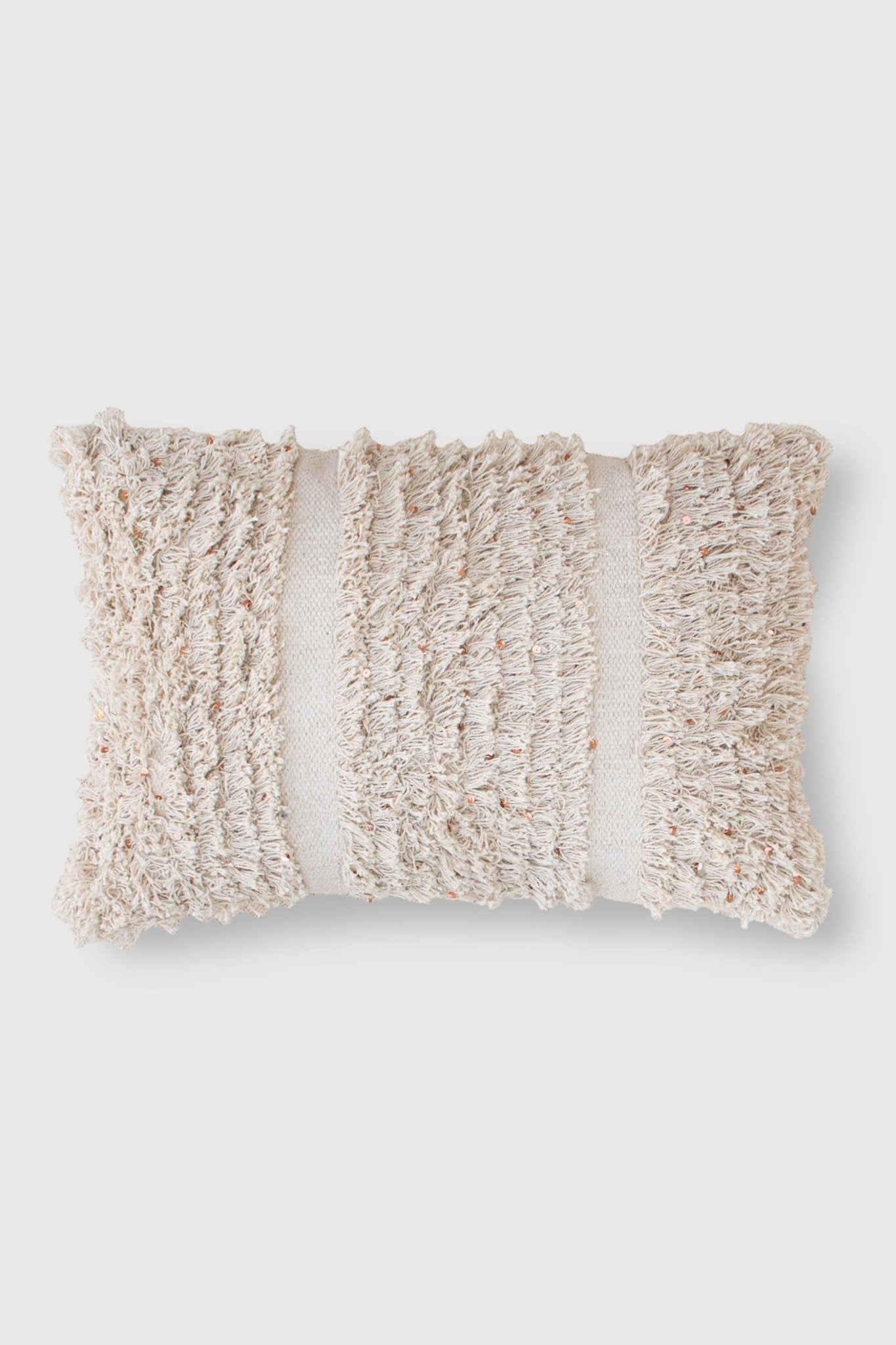 Handwoven sequin shaggy lumbar cushion on sofa — Art Avenue