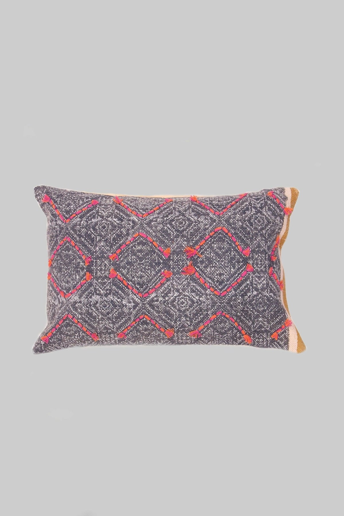 Block-printed embroidered lumbar cushion on sofa — Art Avenue