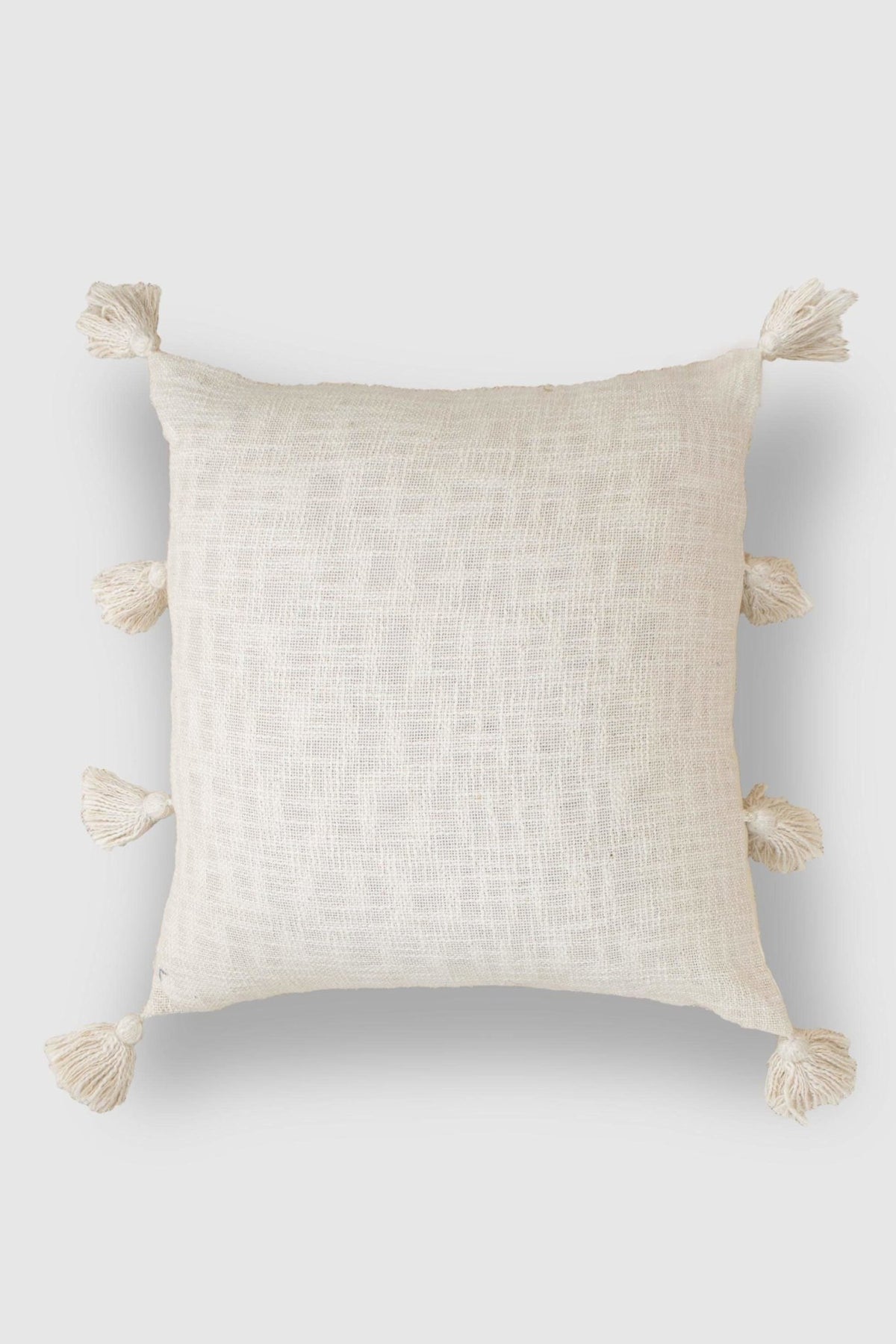 Hand-embroidered square cushion on sofa — Art Avenue