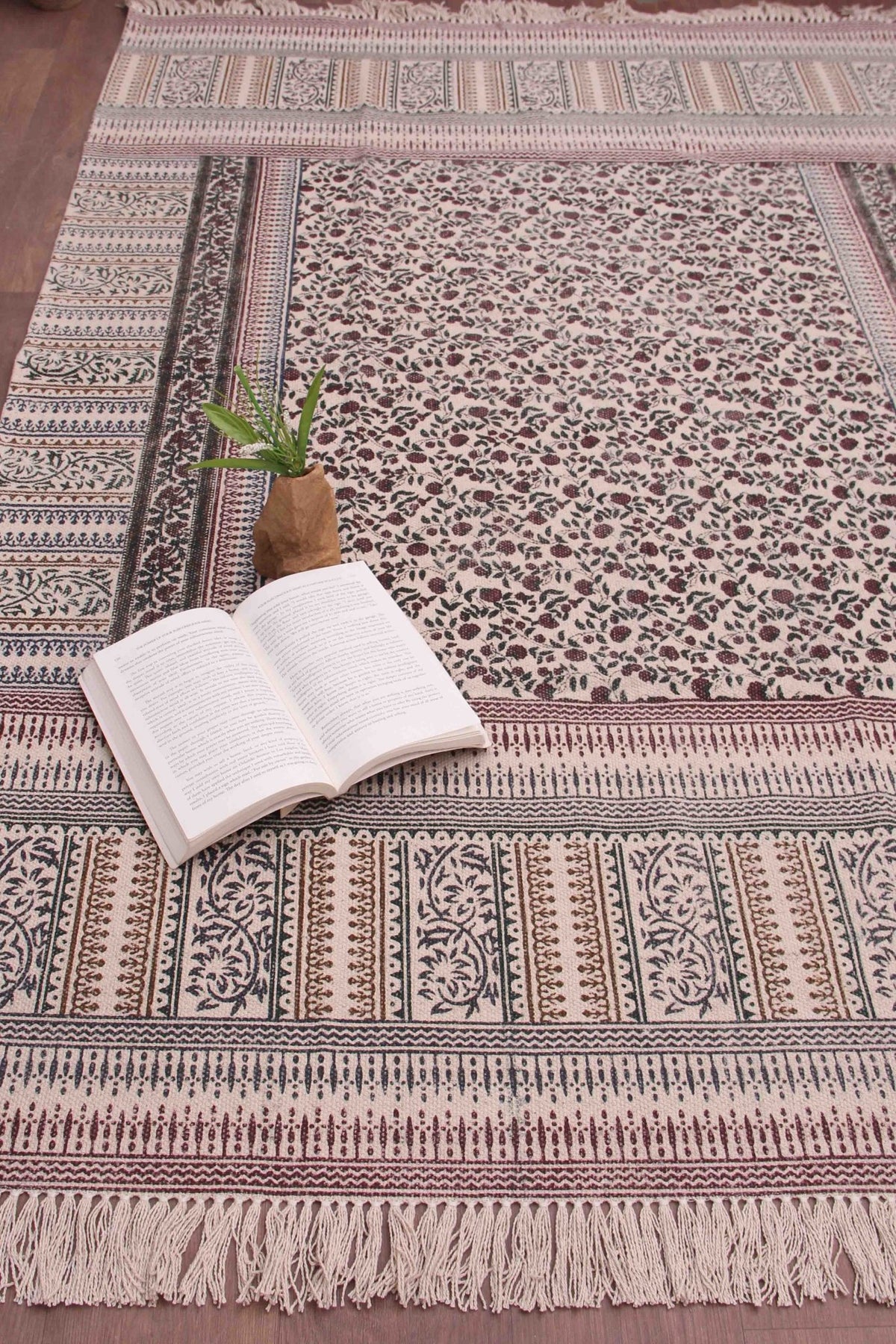 Detail of floral block-print on brown and green dhurrie rug — Art Avenue